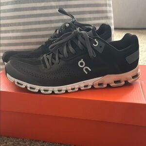 On Running Black Athletic Shoes with Breathable Upper and Unique Sole Design